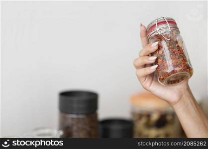 woman holding jar with spices with copy space