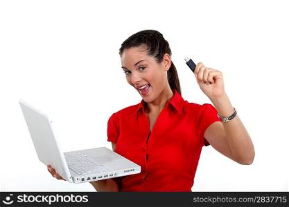 Woman holding laptop and USB key