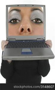 Woman holding laptop in front of face. Giant face in screen.