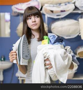 woman holding laundry clothing iron