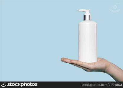 woman holding liquid soap bottle
