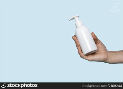 woman holding liquid soap bottle with copy space