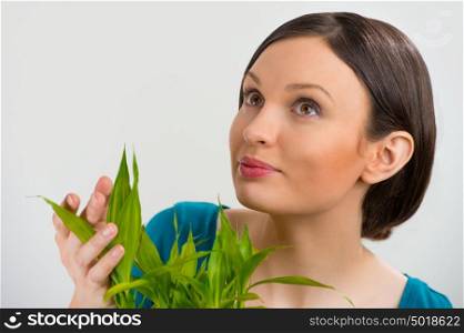 Woman holding lucky bamboo plant and taking care of it