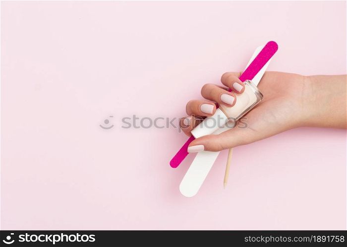 woman holding manicure tools with copy space. Resolution and high quality beautiful photo. woman holding manicure tools with copy space. High quality and resolution beautiful photo concept
