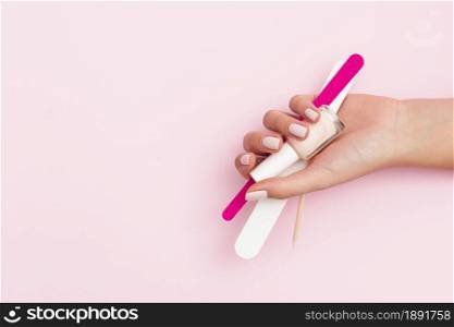 woman holding manicure tools with copy space. Resolution and high quality beautiful photo. woman holding manicure tools with copy space. High quality and resolution beautiful photo concept