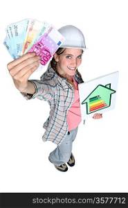 Woman holding money and energy rating card