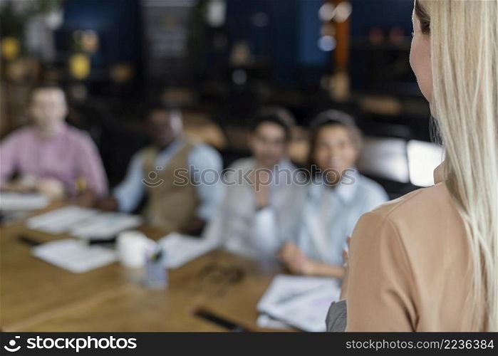 woman holding office meeting with coworkers