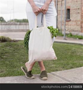 woman holding organic bag with parley dill