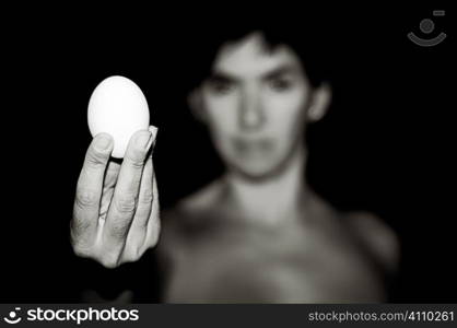 Woman holding out an egg