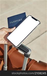 woman holding passport smartphone with luggage airport during pandemic