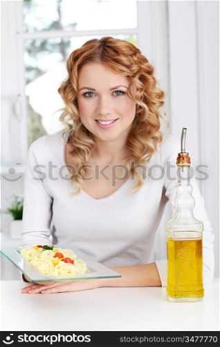 Woman holding pasta dish plate