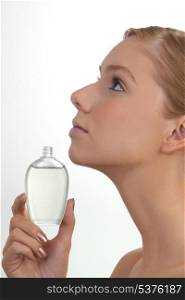 Woman holding perfume bottle