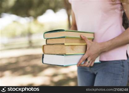 woman holding pile books