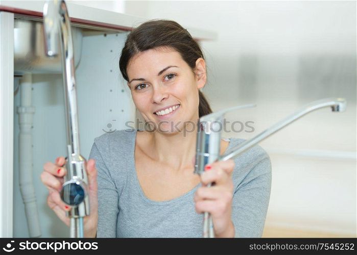woman holding plumbing sink materials
