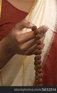 Woman holding prayer beads