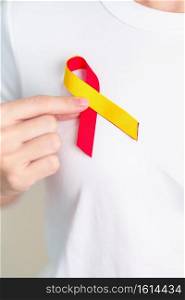 woman holding Red and Yellow ribbon. World hepatitis day awareness month, 28 July, Liver cancer, Jaundice, Cirrhosis, Failure, Enlarged, Hepatic Encephalopathy and Health concept