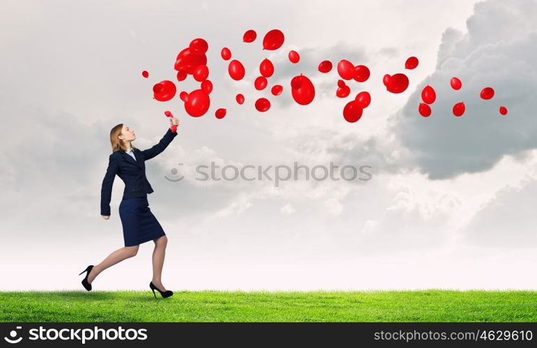 Woman holding red phone handset. Young businesswoman with red phone receiver in hands