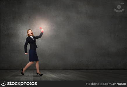 Woman holding red phone handset. Young businesswoman with red phone receiver in hands