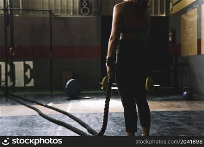 woman holding rope gym