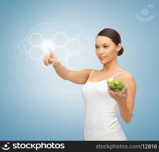 woman holding salad and working with virtual screen