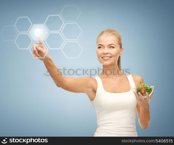 woman holding salad and working with virtual screen