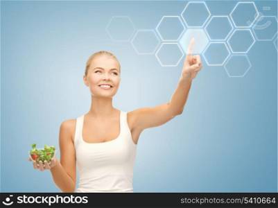 woman holding salad and working with virtual screen