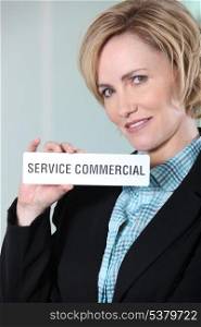 Woman holding Service Commercial sign