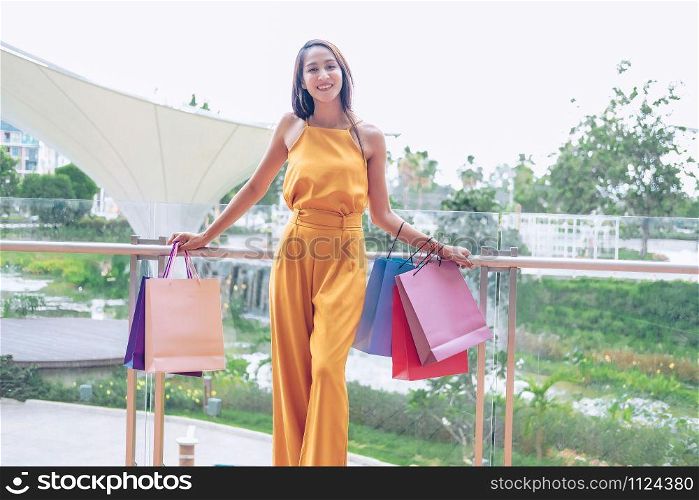 woman holding shopping bags. consumerism shopaholic lifestyle in mall