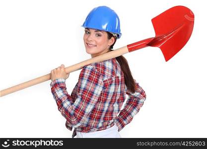 Woman holding shovel over shoulder