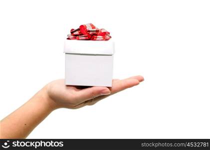 Woman holding small gift with red ribbon over white background