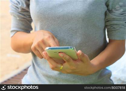Woman holding smartphone in hand and are using