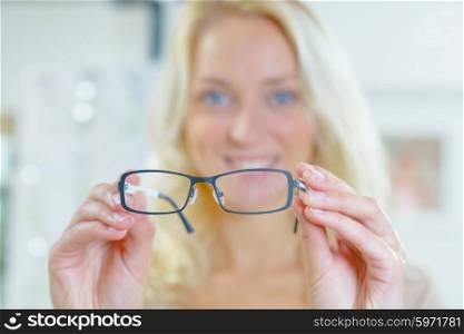 Woman holding spectacles