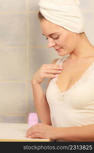 Woman holding stick deodorant in hands. Girl in bathroom towel on head with antiperspirant cosmetics. Daily skin care and hygiene.. Woman holds stick deodorant cosmetic in hands