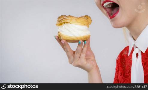 Woman holding sweet cupcake cake dessert with cream, she wants to eat it.. Woman holding cupcake dessert with cream