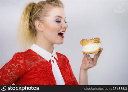 Woman holding sweet cupcake cake dessert with cream, she wants to eat it.. Woman holding cupcake dessert with cream