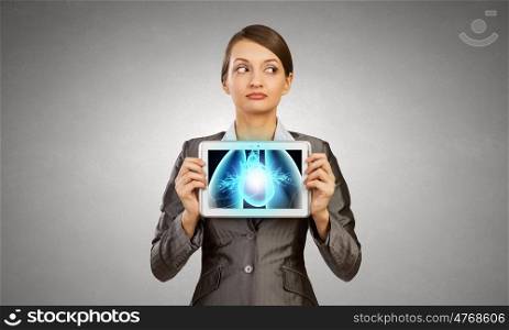 Woman holding tablet pc with lungs xray concept. X-ray of lungs