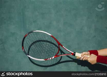 woman holding tennis racket both hands