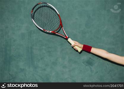 woman holding tennis racket hand