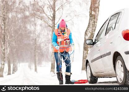 Woman holding tire chains car snow broken problems winter young