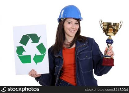 Woman holding trophy and recycle logo