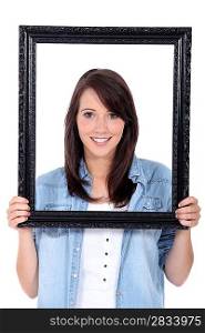 Woman holding up a picture frame
