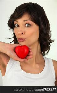 Woman holding up a red heart