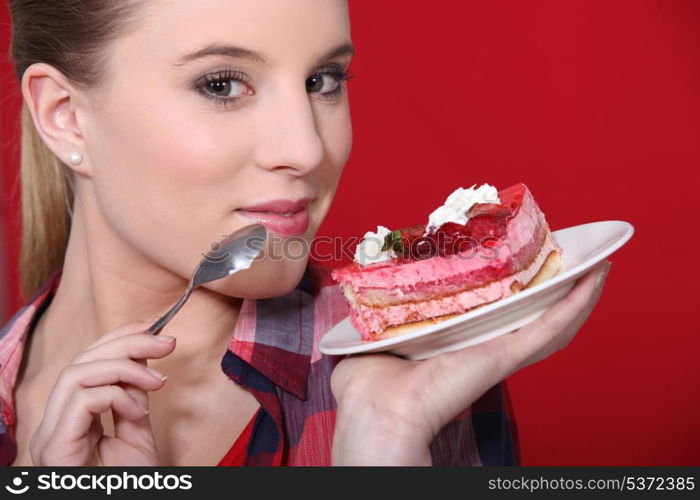 Woman holding up a scrumptious piece of cake