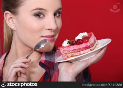 Woman holding up a scrumptious piece of cake