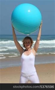 Woman holding up an exercise ball