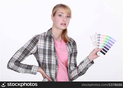 Woman holding up paint samples