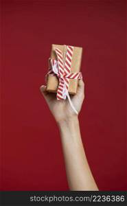 woman holding up wrapped gift