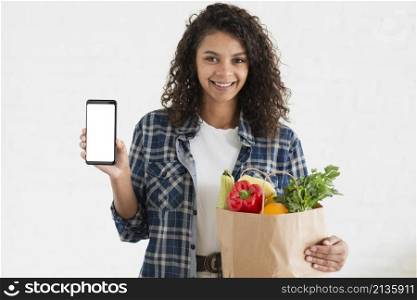 woman holding vegetables bag phone mock up