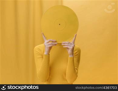 woman holding vinyl front face yellow scene