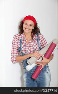 Woman holding wallpaper rolls for the house